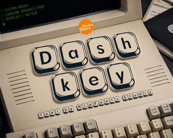 May include: A beige vintage computer with a screen displaying SYSTEM READY, LOADING DASHKEY.FONT, and DISPLAY: ACTIVE. Large white keys with black letters spell DASH KEY, with the text font by hipfonts studio printed below in small letters.