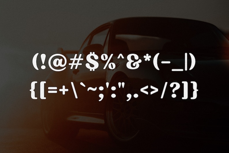 May include: A dark, silhouetted sports car is visible in the background behind two lines of white text. The first line displays (!@#$%^&*(-_|). The second line displays {[=+`~;':",.<>/?]} in a bold, sans-serif font style.