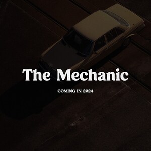 May include: A high-angle view of a tan sedan parked on a dark surface. The text "The Mechanic" appears in white serif font in the center, with the text "COMING IN 2024" positioned directly below it in a smaller, bold white sans-serif typeface.