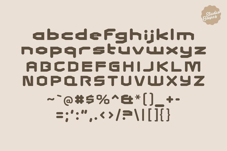 May include: A full alphabet and symbols in a bold, geometric font. Uppercase and lowercase letters are displayed in a dark brown colour against a light beige background. The words "Studio Basics" are in a circular logo in the upper right corner.