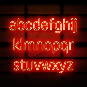 May include: Red neon letters spelling out the alphabet on a brick wall background.