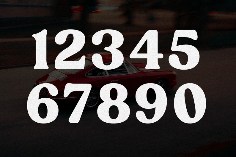 May include: A graphic design featuring the white numbers 1, 2, 3, 4, 5, 6, 7, 8, 9, and 0 arranged in two rows. Behind the numbers, a red sports car is captured in motion on a dark road, creating a blurred background effect that highlights the bold typography.
