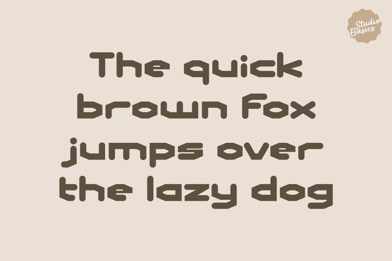 May include: A beige background with the phrase "The quick brown Fox jumps over the lazy dog" in a brown, blocky font. A small circular logo in the upper right corner reads "Studio Basics".