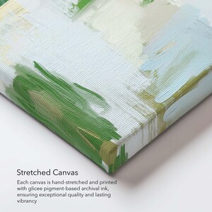 May include: A stretched canvas art print with an abstract design. The artwork features green, white, and light blue brushstrokes. The text "Stretched Canvas" and details about the print quality are visible. The canvas is hand-stretched and printed.