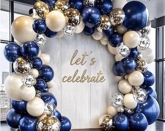 May include: A balloon arch with navy blue, gold, silver, and cream-colored balloons. The balloons are arranged in an arch shape with the words "let's celebrate" in gold script.
