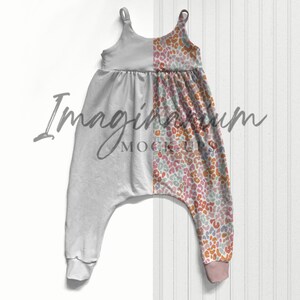 May include: A gray and white jumpsuit with a colorful animal print on one leg. The jumpsuit has a scoop neck and thin straps.