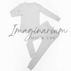 May include: A white long-sleeved shirt and matching pants, both made of a soft, comfortable fabric. The shirt has a crew neck and the pants have a straight leg. The set is laid out flat on a white background.