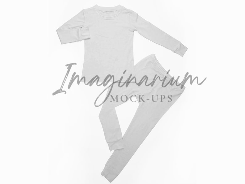 May include: A white long-sleeved shirt and matching pants, both made of a soft, comfortable fabric. The shirt has a crew neck and the pants have a straight leg. The set is laid out flat on a white background.