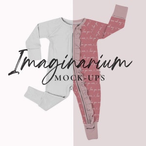 May include: A white and pink baby onesie with a zipper down the front. The onesie has a ruffled trim and a pattern of "love you more" written on it. The onesie is on a white and pink background.