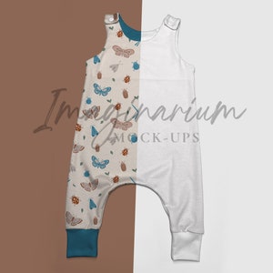 May include: A white and blue baby jumpsuit with a butterfly and insect print on one side and a plain white side. The jumpsuit has a sleeveless design and a relaxed fit.