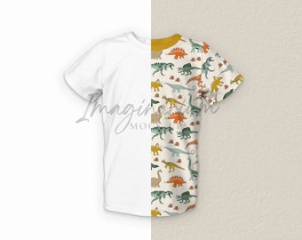 May include: White t-shirt with a dinosaur pattern on the right side. The pattern features green, orange, and yellow dinosaurs on a cream background.