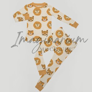 May include: A set of pajamas for children featuring a cream background with a repeating pattern of orange lion faces. The pajamas include a long-sleeved shirt and matching pants.