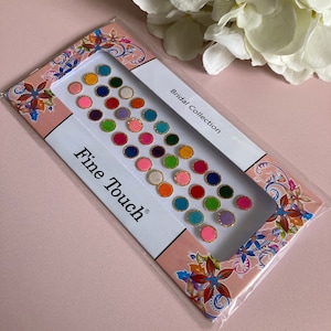 May include: A sheet of colourful round stickers with gold trim. The stickers are arranged in rows and are labelled "Bridal Collection" and "Fine Touch".