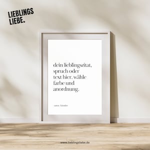 May include: A framed white print with black text that reads "dein lieblingszitat, spruch oder text hier. wähle farbe und anordnung." The top left corner has the text "LIEBLINGS LIEBE." The bottom of the print has the text "-autor/künstler" and "www.lieblingsliebe.de."