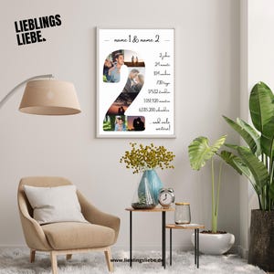 May include: A framed print with the text "name 1 & name 2" and a large number "2" composed of several photos. The print also includes text indicating time passed in years, months, weeks, days, minutes, and seconds. The words "LIEBLINGS LIEBE" are in the upper left corner.