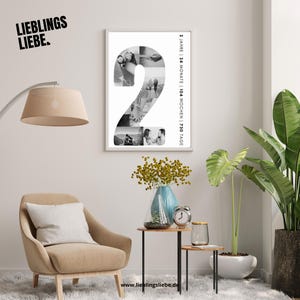 May include: A framed black and white photo collage in the shape of the number 2, filled with multiple images. The frame is white, and the text "2 Jahre | 24 Monate | 104 Wochen | 730 Tage" is printed vertically. The word "LIEBLINGS LIEBE" is printed in black.