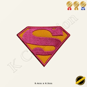 May include: Pink and yellow embroidered iron-on patch of the Superman logo. The patch is 8.4 cm by 6.3 cm.