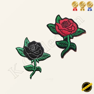 Puede incluir: Dos parches bordados para planchar con forma de rosas. Una rosa es roja y la otra es negra.