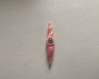 Green eye creature sculpture