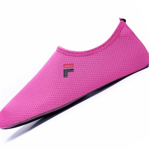 May include: Pink water shoes with a black "F" logo on the top. The shoes have a mesh design and a black sole.