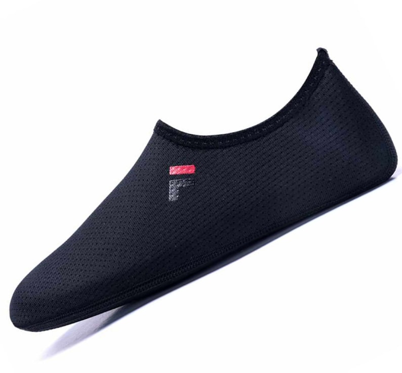 May include: Black mesh water shoes with a red and white logo that says "Fila" on the side.