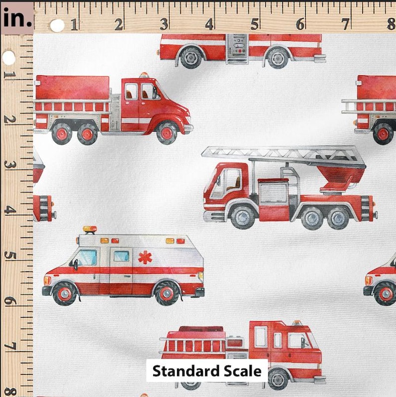 May include: A white fabric with a repeating pattern of red fire trucks and an ambulance. The fire trucks have ladders and hoses. The ambulance has a red cross on the side. The fabric is measured in inches.