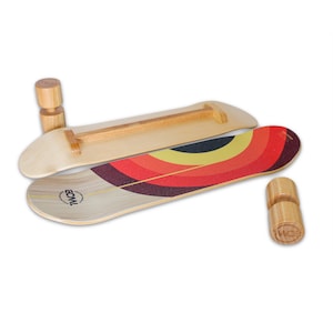 May include: A wooden balance board with a red, yellow, and black striped design. The board has a wooden bar across the middle and is labeled 'ECML' on the bottom. The board is accompanied by two wooden blocks with the same logo.