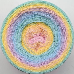 May include: A skein of yarn in a rainbow ombre colourway, starting with yellow, then transitioning to light green, light blue, lavender, and ending with pink.