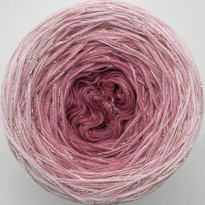 May include: A skein of pink and white ombre yarn with gold glitter thread woven throughout.