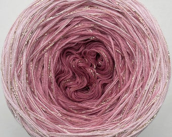 May include: A skein of pink and white ombre yarn with gold glitter thread woven throughout.