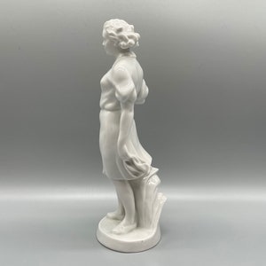 Art Deco porcelain figurine of a young woman in the wind, 1930s
