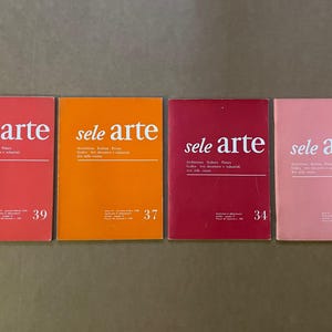 May include: Four vintage "sele arte" magazines in shades of red, orange, and pink. Each magazine cover features the title in white, with issue numbers 30, 34, 37, and 39 visible. The magazines are arranged in a row.