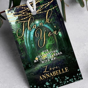 May include: A green and gold thank you tag with a magical forest scene and the text "Thank You for celebrating my Quinceanera with me! Love, Annabelle".