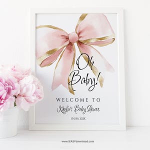 May include: A printable baby shower sign with a pink and gold bow and the text "Oh Baby! Welcome to Kayla's Baby Shower 10|18|202X"