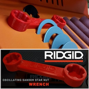 May include: Red plastic wrench with the text "RIDGID" on the handle. The wrench is designed to fit the star nut on a RIDGID oscillating sander. The text "OSCILLATING SANDER STAR NUT WRENCH" is printed below the wrench.