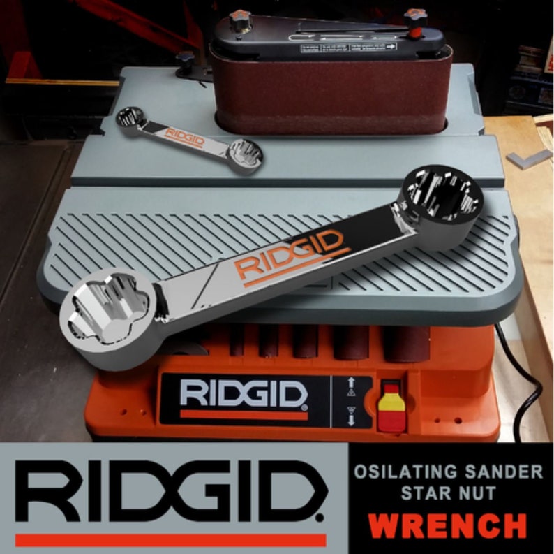 May include: A silver wrench with a star-shaped head and the word "RIDGID" printed on it. The wrench is on top of a grey and orange oscillating sander. The sander has the word "RIDGID" printed on it. The text "OSILATING SANDER STAR NUT WRENCH" is printed on the front of the sander.