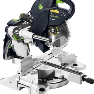 May include: A black and green Festool KS 120 REB compound miter saw with a large blade and a silver base. The saw has a green handle and a dust collection port.