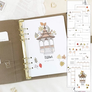 May include: A printable planner page with a fall theme. The page features a hand-drawn illustration of a gazebo with autumn leaves and the word "October" written below. The page also includes a calendar grid with the days of the week labeled M-F-S-S. The planner page is designed for use in a disc-bound planner.