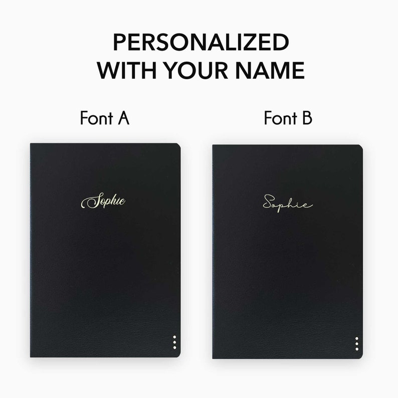 May include: Two black leather notebooks with gold lettering. The notebooks are personalized with the name "Sophie" in two different fonts. Font A is a cursive script font. Font B is a more modern, sans-serif font.