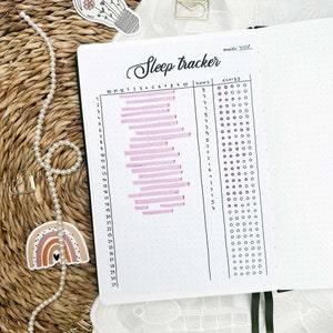 May include: A sleep tracker for the month of November. The tracker has a column for hours slept and a column for energy levels. The hours slept column has a pink bar graph showing the number of hours slept each day. The energy levels column has a grid of circles that can be filled in to indicate energy levels.