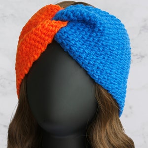 May include: A blue and orange crocheted headband with a knotted design.