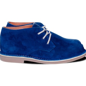 May include: Blue suede chukka boots with white laces. The boots have a cream-colored sole.