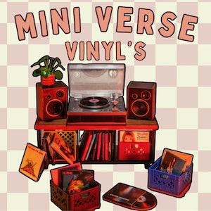 May include: A miniature record player set with two speakers on a wooden stand, featuring a collection of vinyl records in small plastic crates. The text MINI VERSE VINYL'S is displayed above the setup against a light pink and white checkered background.
