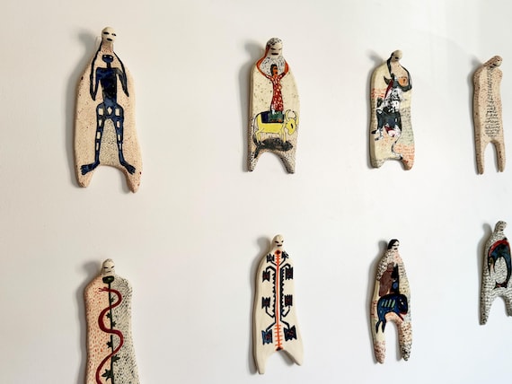 A handmade ceramic sculpture collection exploring human form and social theory — wall art that makes you think as much as it makes you stare.