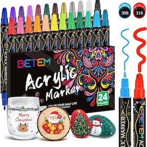 May include: A set of 24 acrylic markers in various colors, with a black box featuring the text "Acrylic Marker" and "24 Colors." The image also includes a glass with "Merry Christmas" text, a wooden slice with Santa, and painted rocks.