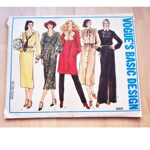 May include: A vintage Vogue's Basic Design sewing pattern with five different dress designs. The pattern is for size 2002.