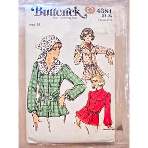 May include: Vintage Butterick sewing pattern D-7 4384. The pattern features illustrations of women's blouses with various designs. The main blouse is green plaid with a white floral collar and cuffs. The pattern includes size 14.