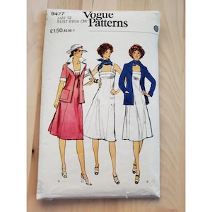 May include: Vogue Patterns sewing pattern number 9477, size 12, bust 34 inches, for a dress with a jacket. The pattern shows three women wearing the dress and jacket in different styles. The dress is white and the jacket is blue.