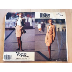 May include: A vintage Vogue Patterns sewing pattern for a DKNY blazer and skirt. The pattern is for sizes 8-10-12. The pattern features two models wearing the blazer and skirt in a tan color.