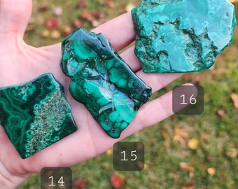 May include: Three green malachite stones of varying sizes and shapes. The stones are labeled 14, 15, and 16.